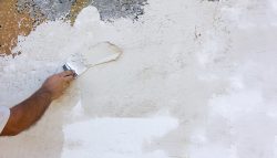 Background,Texture,White,Rough,Plastered,Walls,And,A,Male,Hand